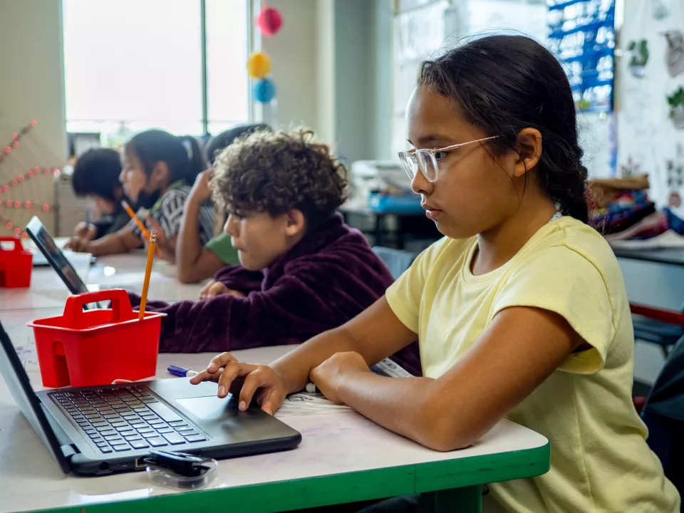 children work on their laptops