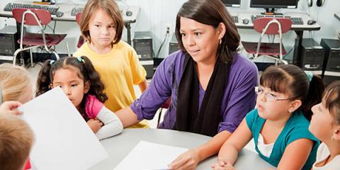 Teacher works with youth in the classroom.