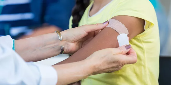 Young Native girl receives vaccination. 