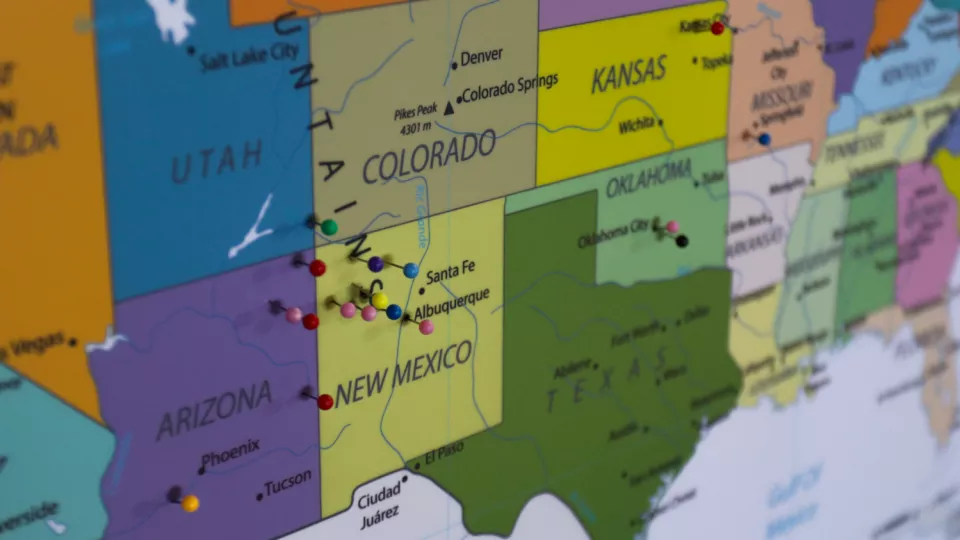 A map of the United States with push pins in different places across several states.