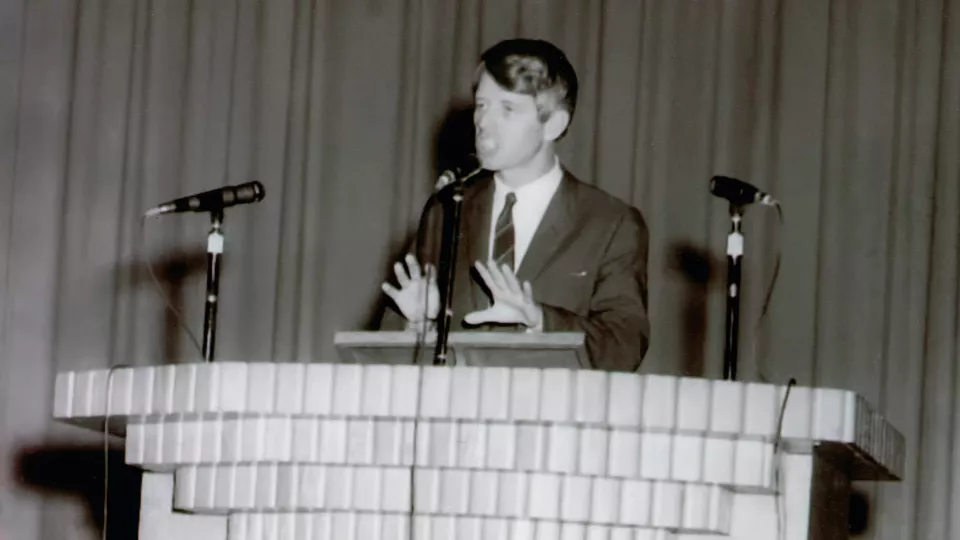 Robert F. Kennedy stands at a podium and gives a speech at Haskell Indian Nations University.